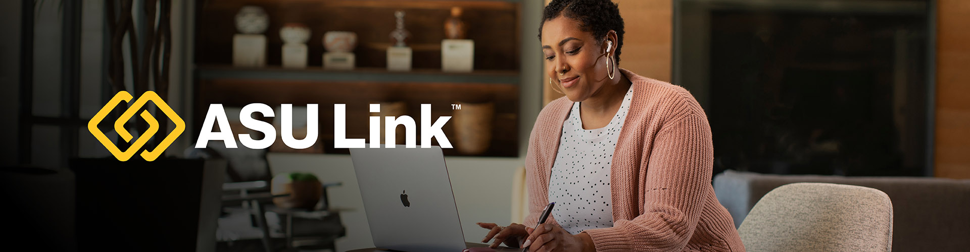 A woman looks at her laptop. The ASU Link logo floats beside her.